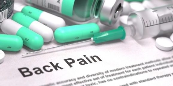 Back Pain – Printed with Mint Green Pills, Injections and Syringe. Medical Concept with Selective Focus.