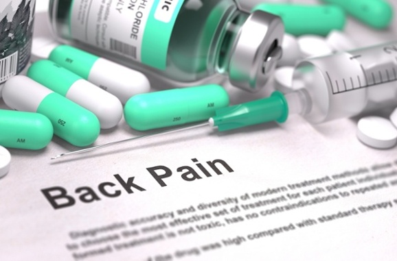 Back Pain – Printed with Mint Green Pills, Injections and Syringe. Medical Concept with Selective Focus.