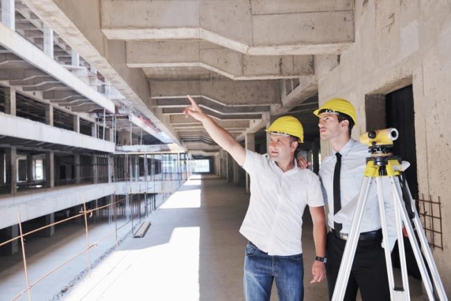 Team of business people in group, architect and engeneer on construciton site check documents and business workflow on new building