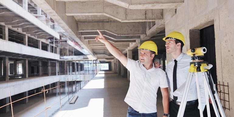 Team of business people in group, architect and engeneer on construciton site check documents and business workflow on new building