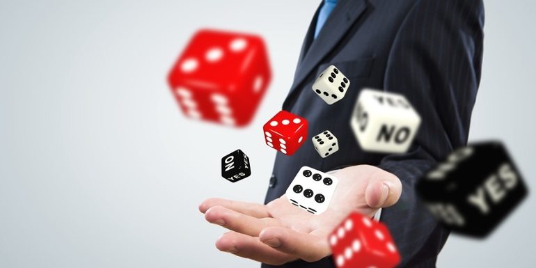 Close up of businessman throwing dice. Gambling concept