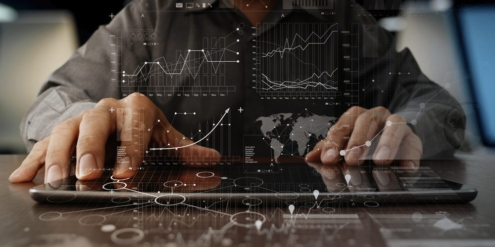 businessman hand working on laptop computer with digital layer business strategy and social media diagram on wooden desk